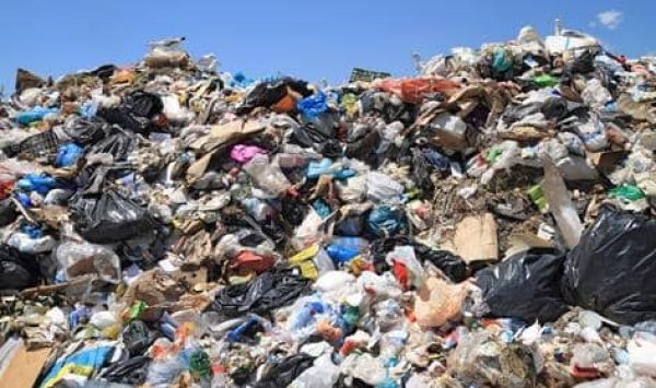 MCD workers and machinery flattening Delhi landfill